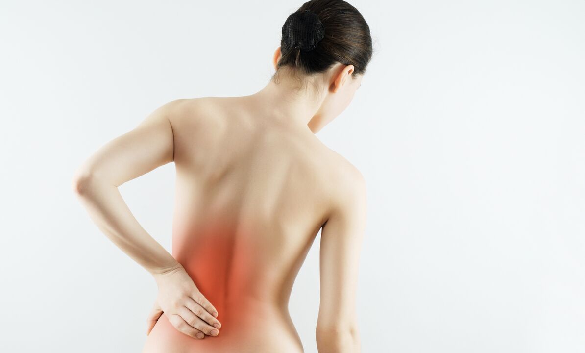 A woman worries about back pain in the lumbar region